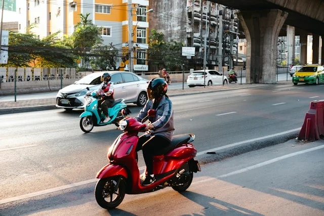 Close-up of motorcycle tires being inspected for wear and pressure